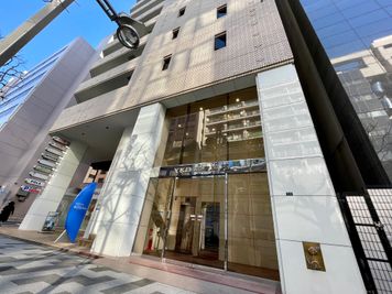 【「YKB新宿御苑」と表示されたガラスドアが建物入口です】 - テレワークブース新宿御苑前 406の外観の写真